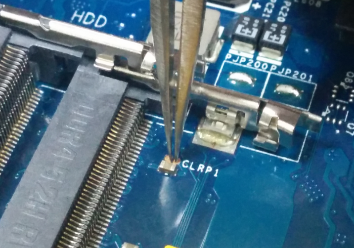 Using pliers or a flat head screwdriver touch both pins simultaneously